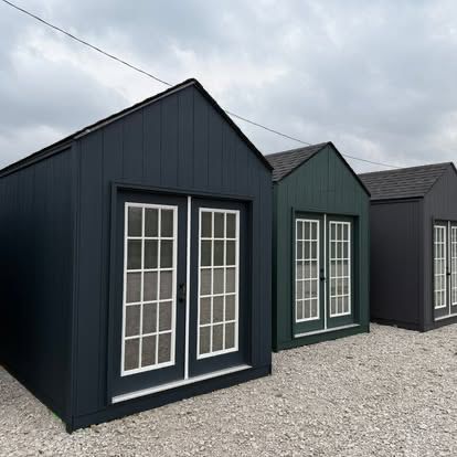 A custom-built outbuilding with French doors and white trim, finished by Hughes Residential Services